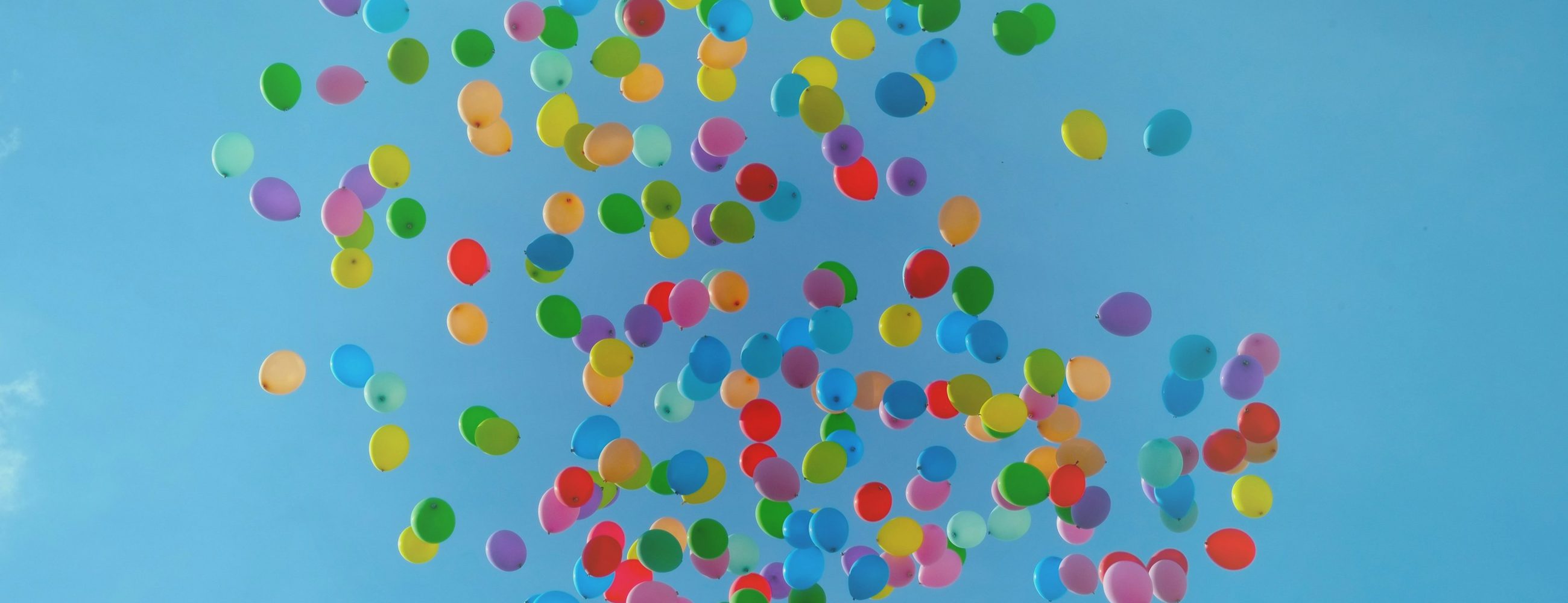 Colourful balloons against a blue sky